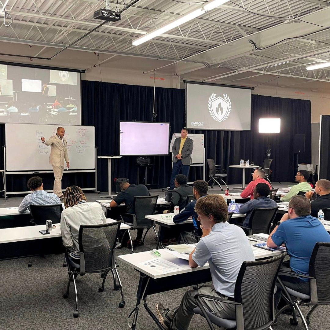 speakers at CYA with classroom full of listeners