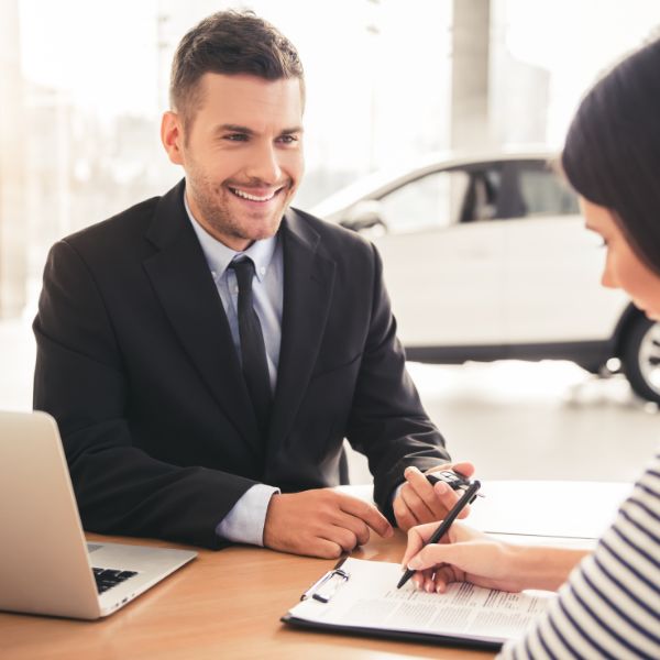 car salesman with laptop
