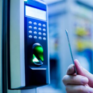 Person putting a card up to an access control.