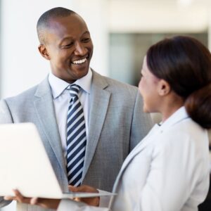Two people looking at a laptop screen.