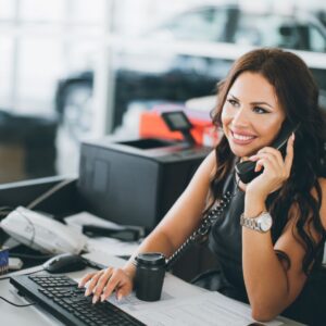 a women on the phone at a dealership