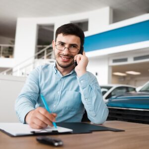 a man on the phone at a dealership