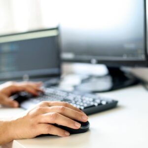 close up of hands typing on keyboard