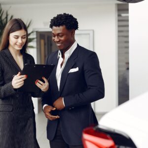 Car dealership salesperson working on a tablet