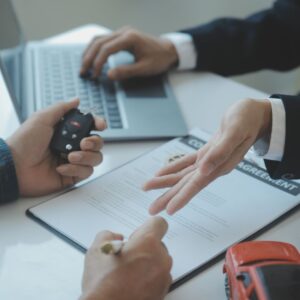 customer filling out paperwork to buy a car