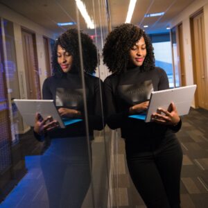 a woman on a laptop near servers