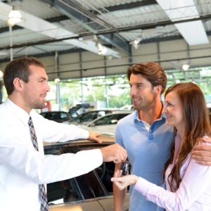 A couple at a car dealership